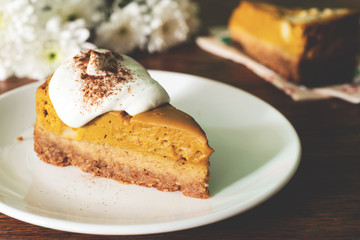 pumpkin pie cheesecake with whipped cream on top