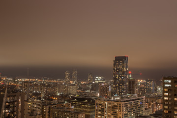 Fototapeta na wymiar Nighttime City Scape with Low Clouds