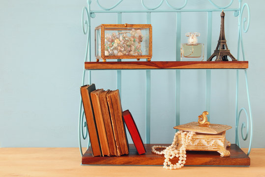 Classic shelf with vintage objects on wooden table.

