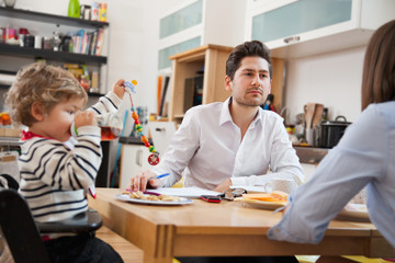 Young Happy Modern Family, at Breakfast at home, before going to Work