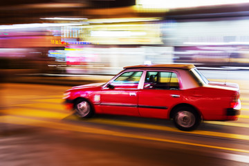 Fototapeta na wymiar Hongkong taxi on the road in motion blur