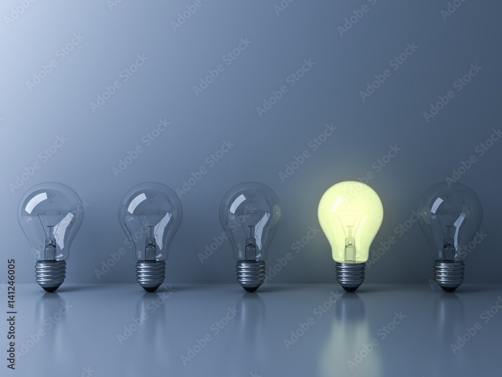 Aufkleber one glowing light bulb standing out from the unlit incandescent bulbs on blue background with reflec