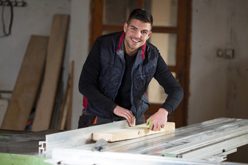 .Carpenter using electric saw