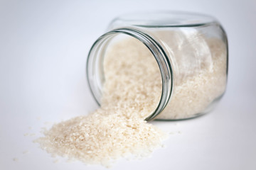 Rice grains in the jar. Isolated on white background