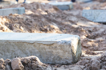 Concrete poles are placed on the ground to support the weight of the foundations of the building.