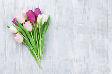 Colorful tulips over wooden background