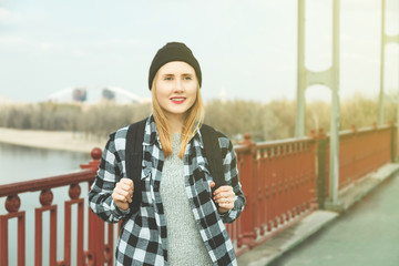 Cheerful woman standing on a bridge