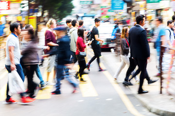 crowd of people crossing a street in Hongkong