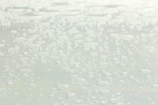Water drop on white roof car, white background