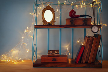 Classical shelf with vintage male objects and blank frame