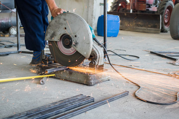 Mechanic use cut off saw machine cutting steel unsafe on protection. - obrazy, fototapety, plakaty