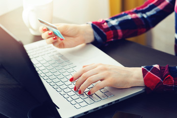 woman using laptop to make online payment with credit card