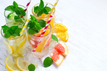 Set of Cucumber grapefruit lemon orange mint  infused water for detox on a white background. Concept of summer drinks
