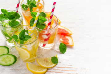 Set of Cucumber grapefruit lemon orange mint  infused water for detox on a white background. Concept of summer drinks