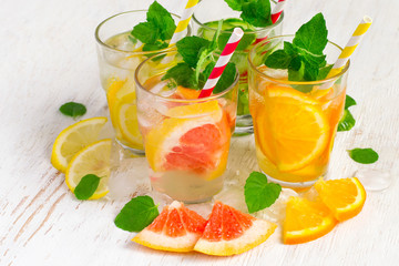 Set of Cucumber grapefruit lemon orange mint  infused water for detox on a white background. Concept of summer drinks