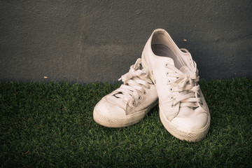 sneaker shoes on grey wall still life vintage style