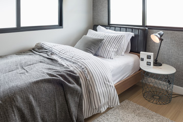 Fototapeta na wymiar set of pillows with blanket on modern wooden bed in modern bedroom