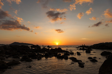 Fototapeta na wymiar Dramatic seascape of rock and sea in the andaman ocean. Colorful sunset in phuket thailand.