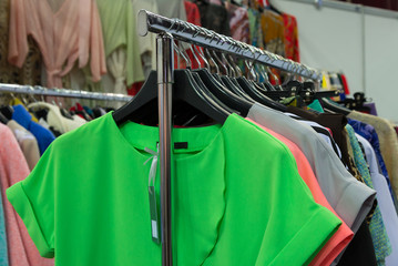 Fototapeta na wymiar Women clothes on hangers in the shop. Selective focus.