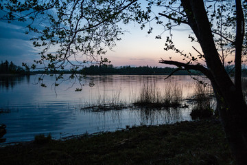 sunset over calm lake beach
