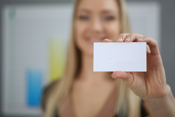 Blond business woman holding a business card hand