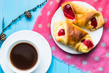 Still life with cup of tea and sweets on the wooden background