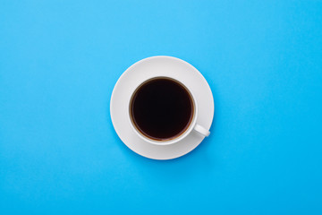 Top view of a dark flavor coffee isolated over blue flatlay