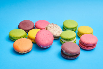 Homemade macaroons lying on a blue flatlay