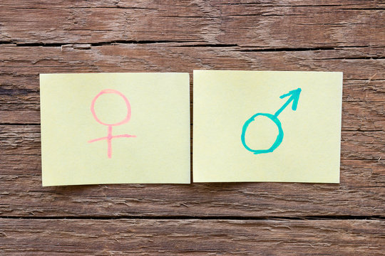 paper notes with the male and female gender symbols closeup