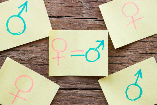 paper note with hand-drawn gender symbols closeup