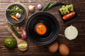 egg prepare in bowl and ingredients on wood background top view