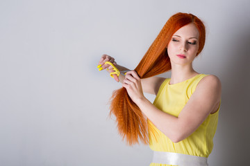 woman with long hair holds scissors