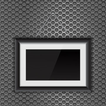Empty black photo frame on metal perforated background