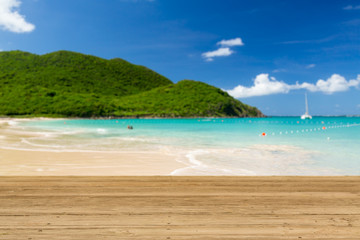 Fototapeta premium Warm sandy beach in caribbean by wooden decking