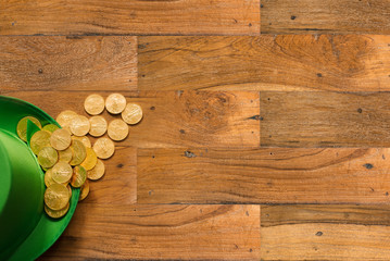 Pile of gold coins inside green hat St Patricks Day