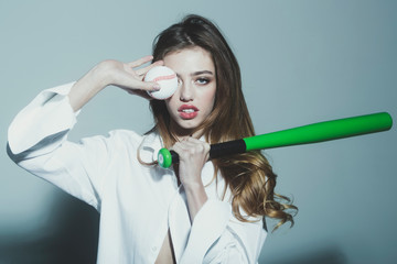 pretty sexy woman with long hair holds green baseball bat