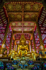 Fototapeta premium THAILAND,CHAINGMAI-Mar 12, 2017: suan dok temple. golden buddha statue with china architecture style.