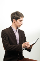 Smart businessman holding a sheet of paper and pen