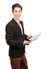 Cheerful young man businessman in suit working on digital tablet and smiling while standing isolated