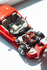 luxury wedding rings on the engine of toy car