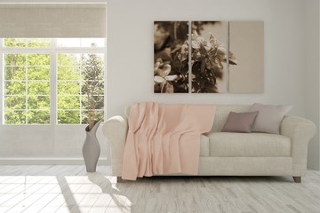 Fototapeta premium White room with sofa and green landscape in window. Scandinavian interior design. 3D illustration
