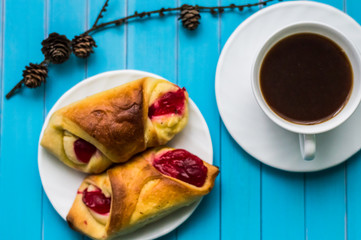 Still life with cup of tea and sweets on the wooden background