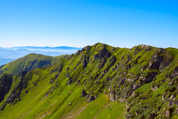 Obraz premium Rocky mountain ridge covered with green grass
