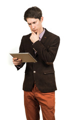 Portrait of handsome man thinking and looking business with a tablet in hand isolated