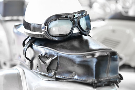 Shredded leather seat of an oltimer motorcycle with helmet and glasses