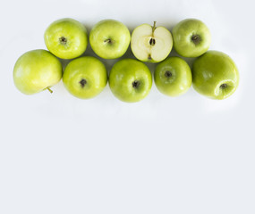 Horizontal seamless background with green apples. Fresh apples on a white background. Apples at border of image with copy space for text.