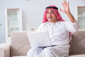 Arab businessman working sitting at couch