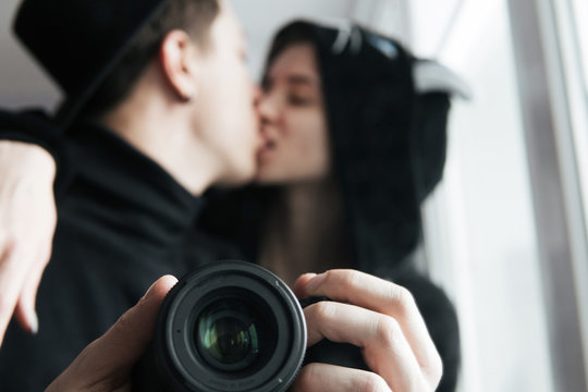 man and woman in black clothes kissing