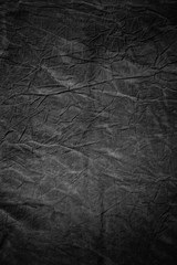 Texture of dark grey crumpled fabric