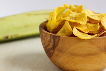 Fried plantain chips in a wooden bowl. © Frantisek Keclik